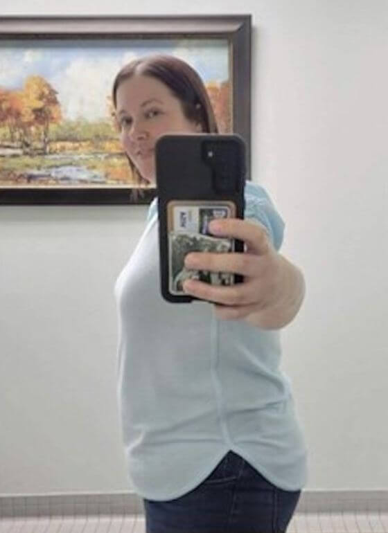 PCOS Sisters A woman taking a selfie in a bathroom before and after her journey with PCOS Weight Loss Treatment