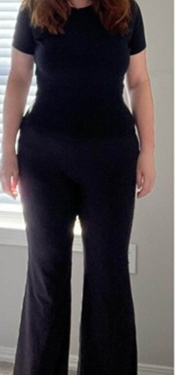 PCOS Sisters A woman wearing black pants and a top.