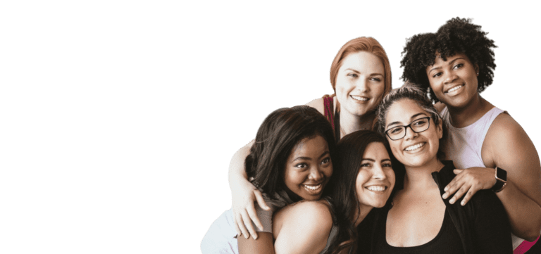 A group of women hugging and smiling for the camera.